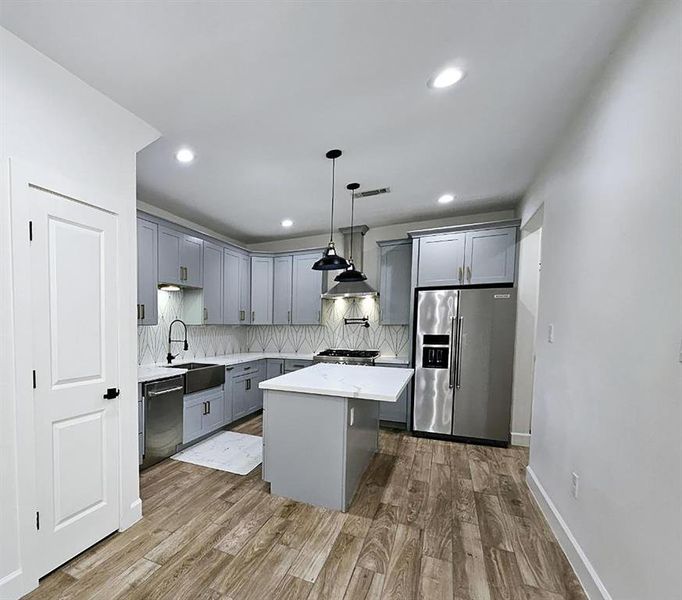 Gorgeous kitchen with quartz countertops, soft close cabinets, pot filler, goose neck faucet, walk-in pantry.