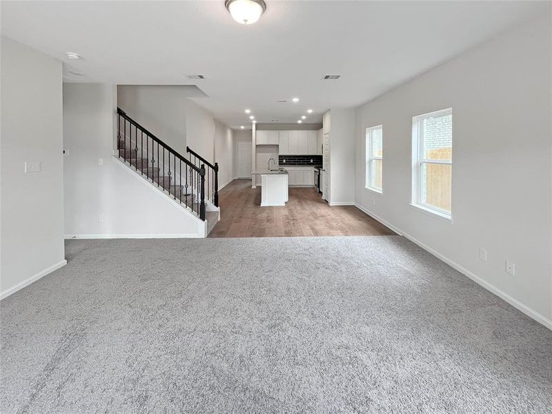 The Waring III- Family Room into Kitchen. Home under construction. Sample floor plan photo used for illustrative purposes only. Upgrades, selections options, windows and colors may vary.