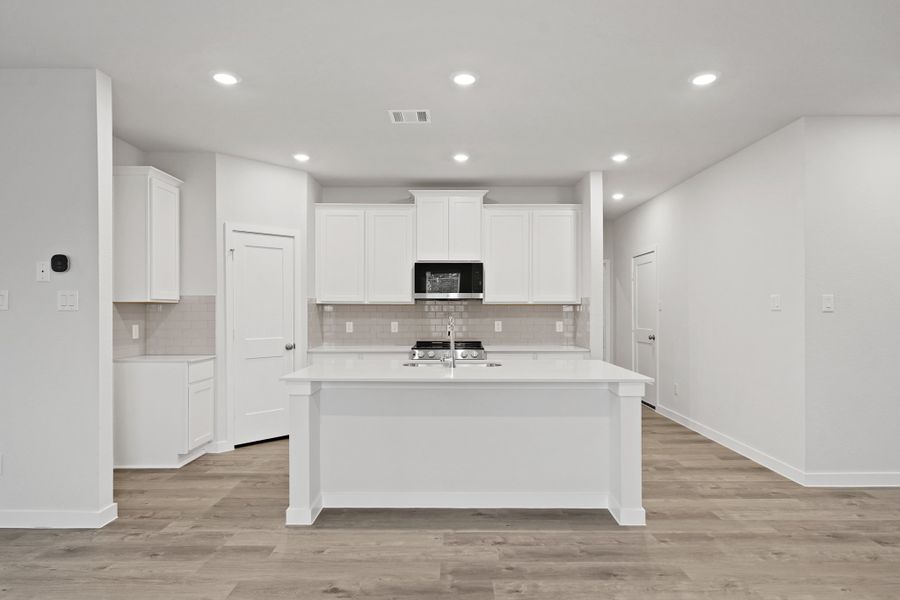 A kitchen with white cabinets. A kitchen with white cabinets.