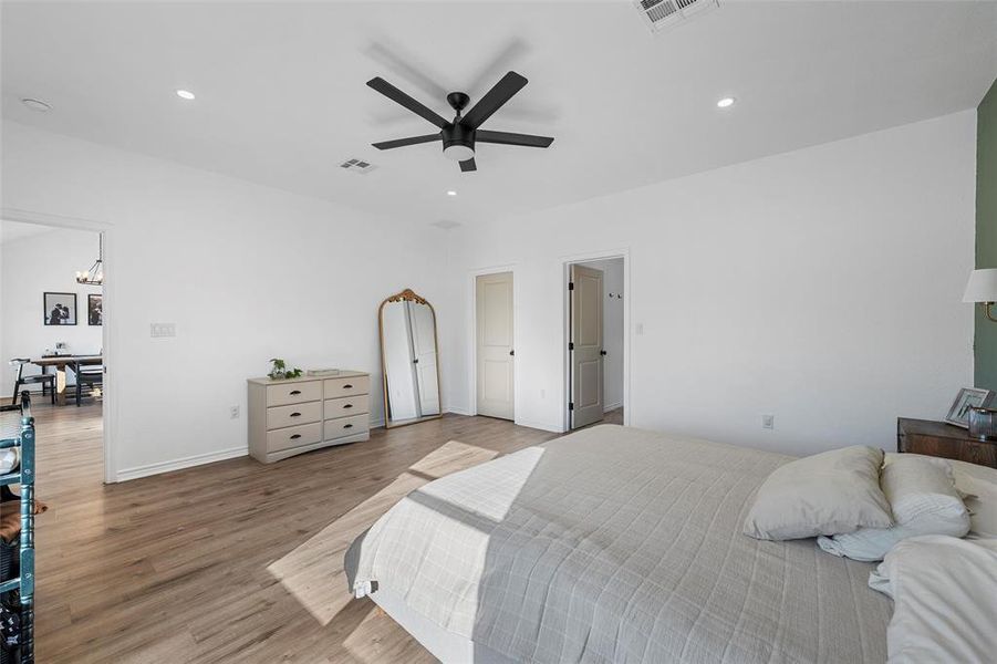 Bedroom featuring wood finished floors, recessed lighting, ceiling fan, and a chandelier