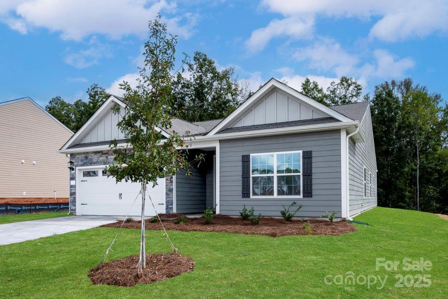 Front exterior of a new home in Colonial Crossing, Troutman, NC, highlighting curb appeal (Image 1). Front exterior of a new home in Colonial Crossing, Troutman, NC, highlighting curb appeal (Image 1).
