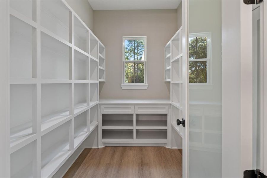 Butler's Pantry with so much storage you won't believe it! Luxury Vinyl Plank on the floors, Glass Pantry Door, it even has drawers for your special silver or serving utensils! Check out that window that allows the natural light to flow in!