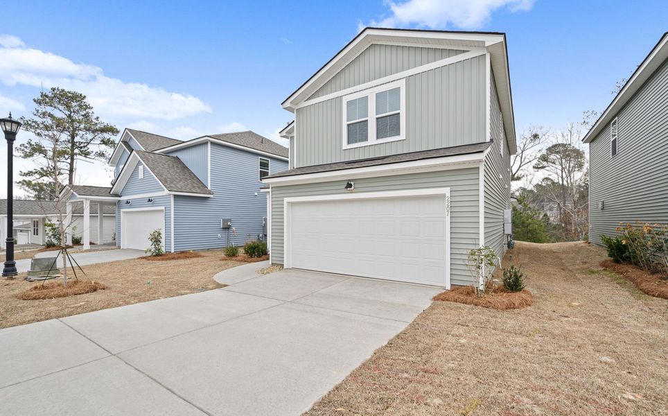 Front exterior of a new home in Grand Arbor, Blythewood, SC, highlighting curb appeal (Image 2). Front exterior of a new home in Grand Arbor, Blythewood, SC, highlighting curb appeal (Image 2).