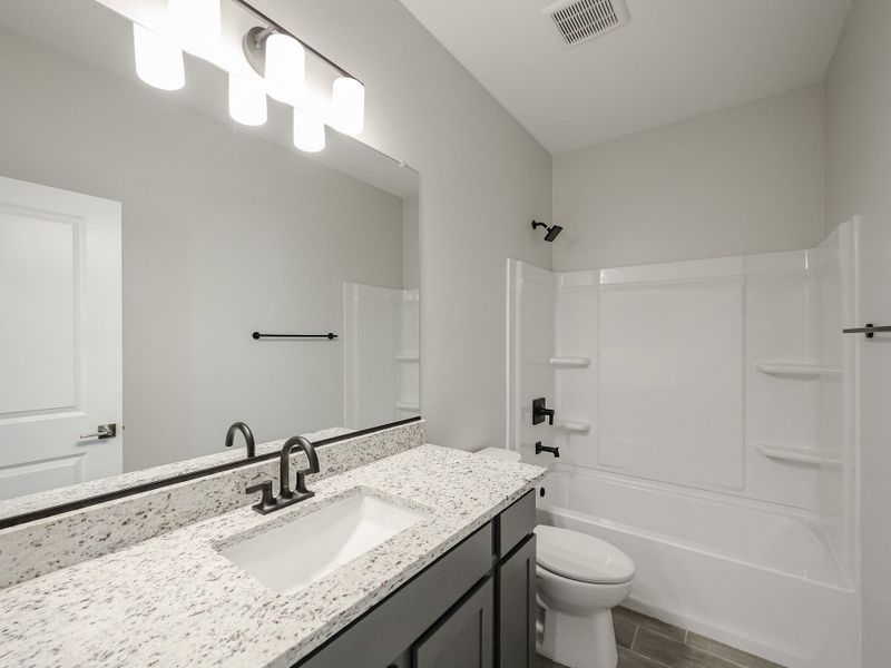 A bathroom with a marble countertop. A bathroom with a marble countertop.