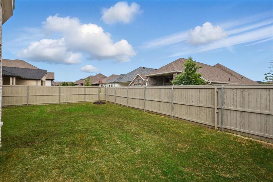 Fenced backyard featuring a residential view