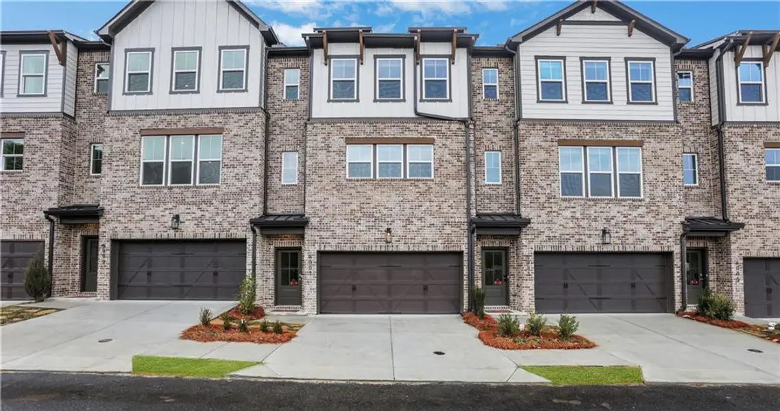 Front exterior of a new home in Towne Village at Suwanee Dam, Sugar Hill, GA, highlighting curb appeal (Image 1). Front exterior of a new home in Towne Village at Suwanee Dam, Sugar Hill, GA, highlighting curb appeal (Image 1).