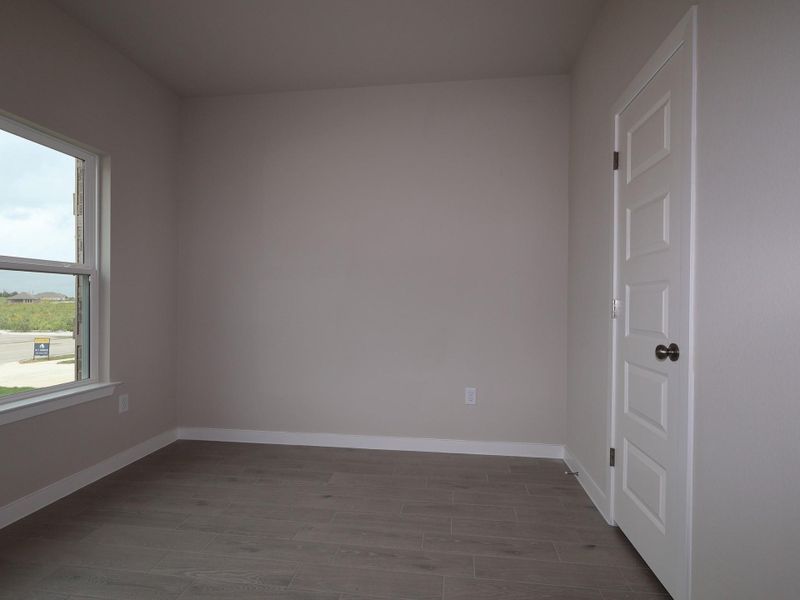 A well-lit room featuring durable tile flooring, ready for your personal touch.