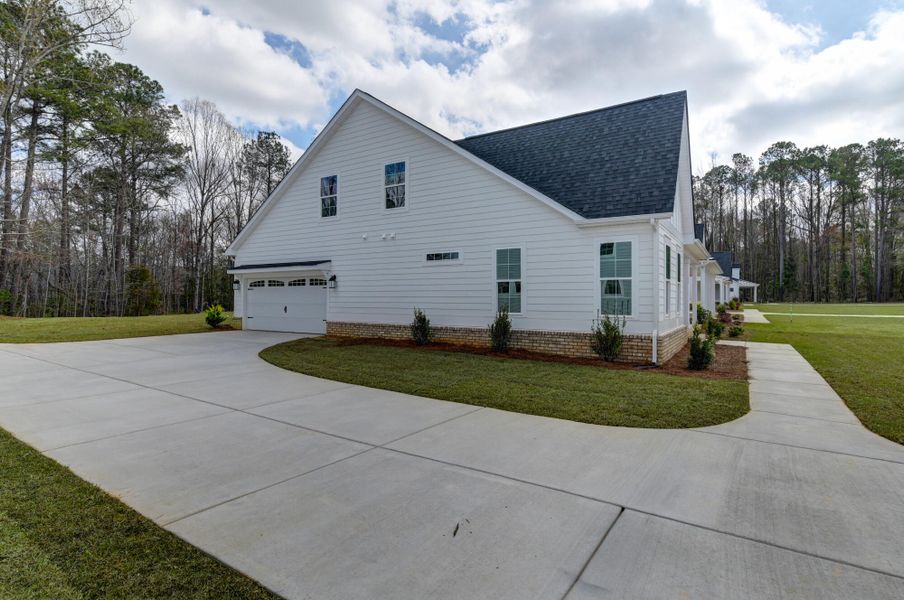 Front exterior of a new home in Clubside Reserve at Summerlake, Lexington, SC, highlighting curb appeal (Image 26). Front exterior of a new home in Clubside Reserve at Summerlake, Lexington, SC, highlighting curb appeal (Image 26).