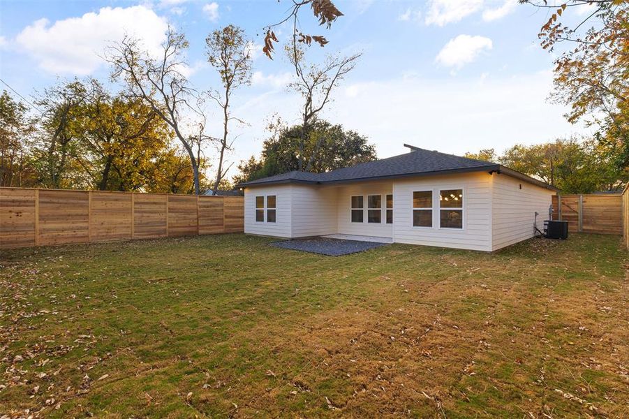 Rear view of house with a patio area and a fenced backyard
