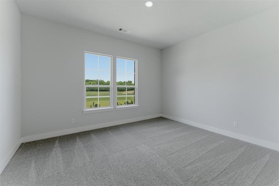 Room featuring dual windows, recessed lighting, neutral wall tones, and gray patterned carpeting