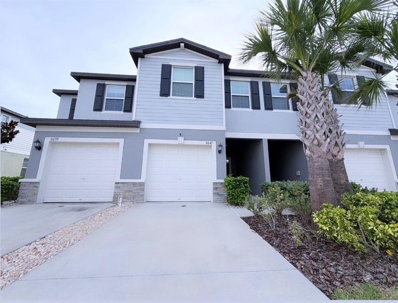 Front exterior of a new home in , Land O' Lakes, FL, highlighting curb appeal (Image 1). Front exterior of a new home in , Land O' Lakes, FL, highlighting curb appeal (Image 1).