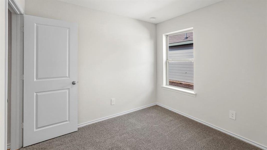 Neutral-toned walls complement the gray carpet flooring