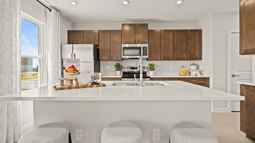 The Kitchen and Island in Model Highbourne by DRB Homes in Hamilton Bluff located in Haines City, FL. The Kitchen and Island in Model Highbourne by DRB Homes in Hamilton Bluff located in Haines City, FL.