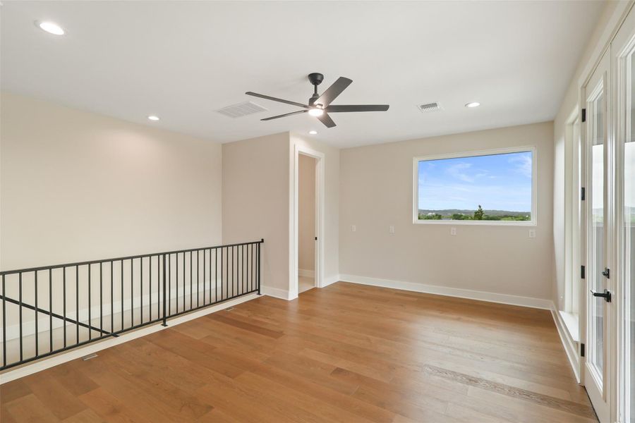 Unfurnished room featuring a ceiling fan, visible vents, light wood-style flooring, and baseboards Unfurnished room featuring a ceiling fan, visible vents, light wood-style flooring, and baseboards