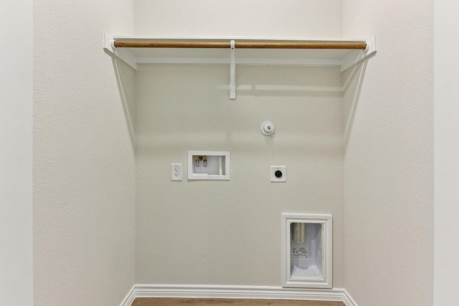 Washroom with hookup for an electric dryer, washer hookup, and gas dryer hookup