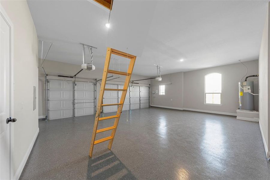 Garage with electric water heater, baseboards, and a garage door opener Garage with electric water heater, baseboards, and a garage door opener