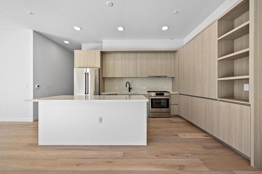 Kitchen featuring light brown cabinets, open shelves, appliances with stainless steel finishes, modern cabinets, and recessed lighting Kitchen featuring light brown cabinets, open shelves, appliances with stainless steel finishes, modern cabinets, and recessed lighting