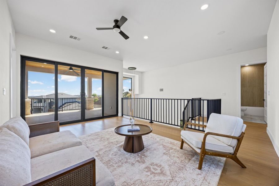 Sitting room featuring ceiling fan, light wood-style floors, and recessed lighting