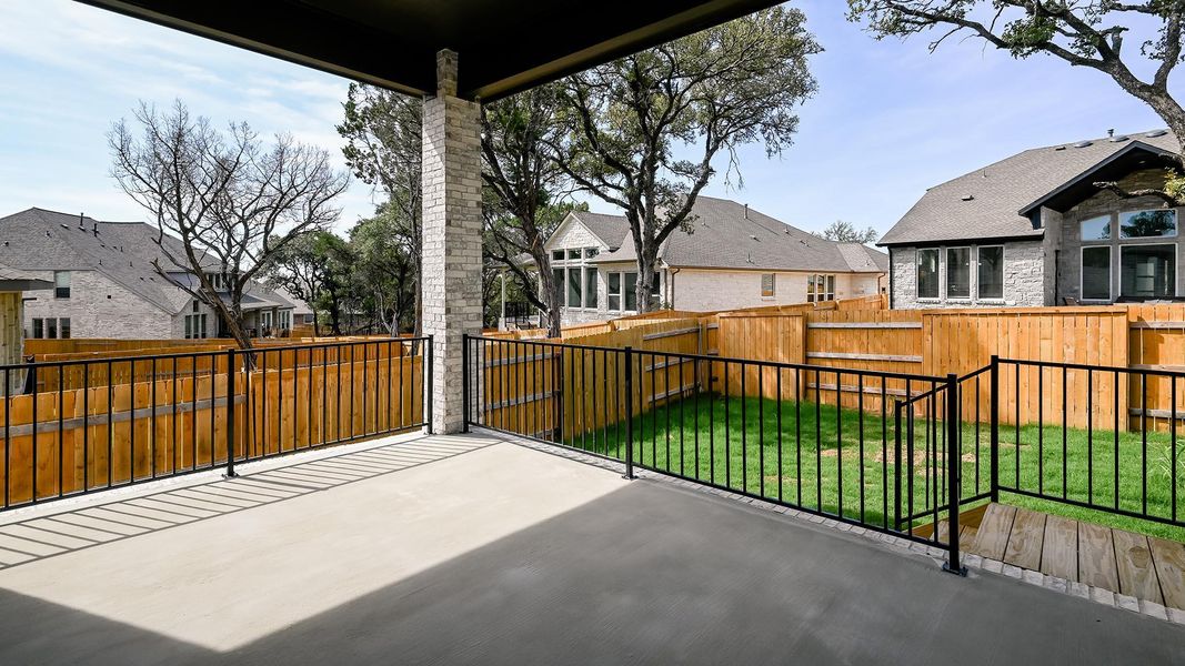 Fenced backyard with a residential view and a patio