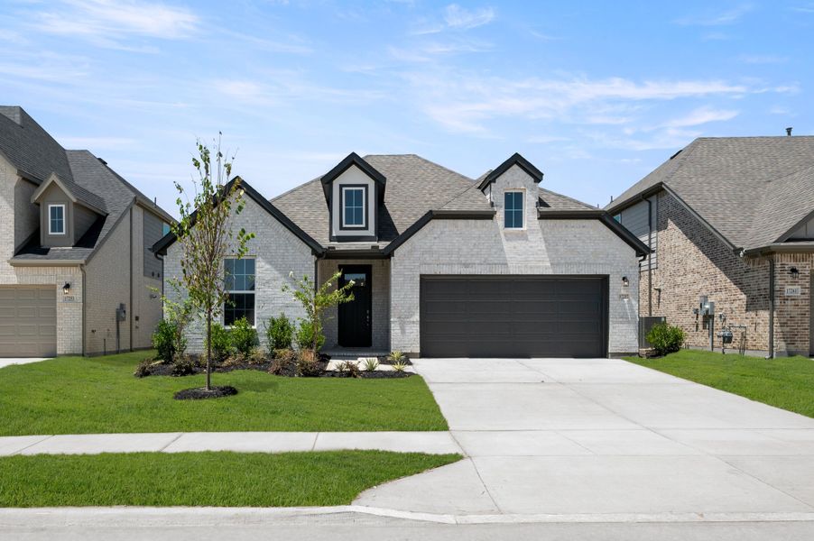 Representative exterior photo of a completed home built from the Valor by Rockwell Homes in Wildflower Ranch, Justin, TX (Image 24).
