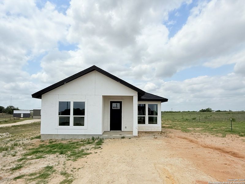 Front exterior of a new home in , La Vernia, TX, highlighting curb appeal (Image 2). Front exterior of a new home in , La Vernia, TX, highlighting curb appeal (Image 2).