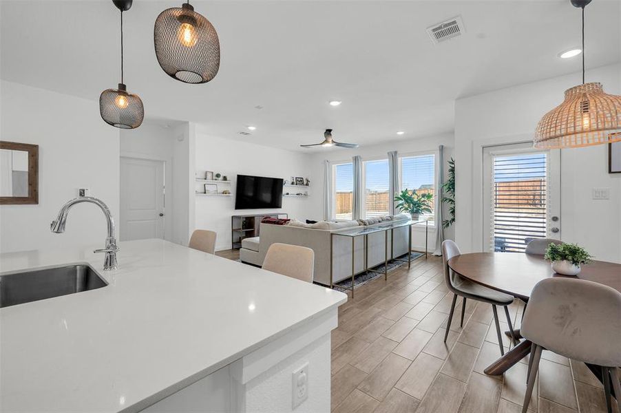 Kitchen with ceiling fan, decorative light fixtures, and sink