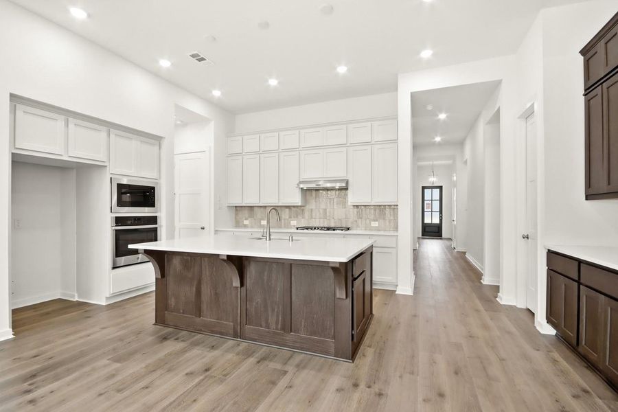 Kitchen featuring open sightline to front door.