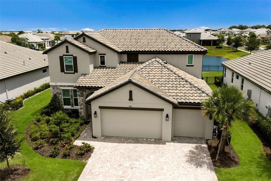 Front exterior of a new home in Sweetwater at Lakewood Ranch, Bradenton, FL, highlighting curb appeal (Image 25).