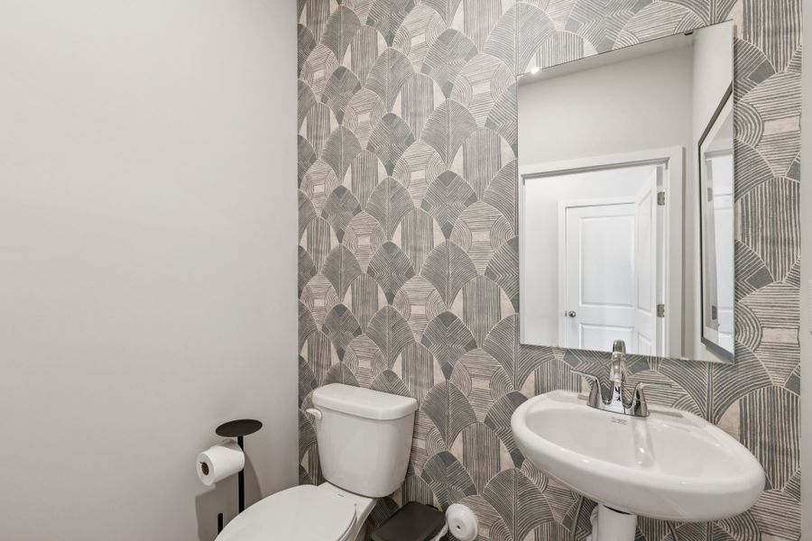 A bathroom with a sink and toilet.