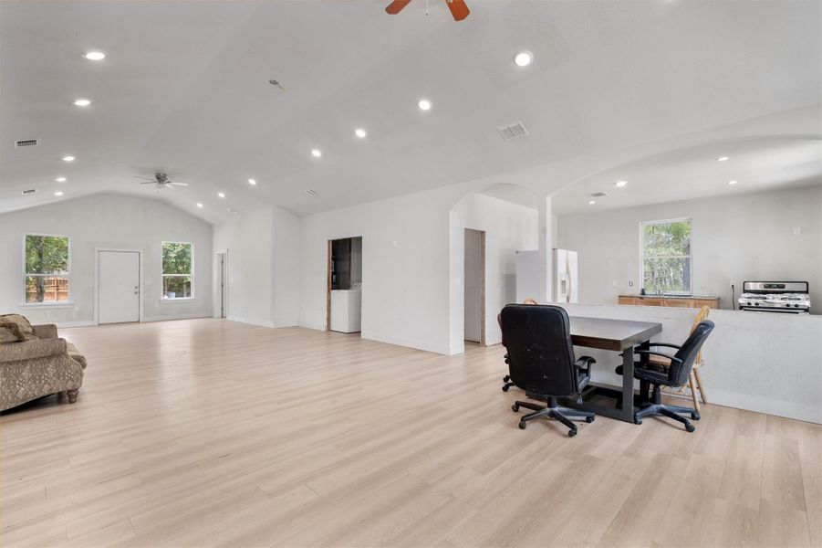 Office space featuring ceiling fan, recessed lighting, vaulted ceiling, light wood finished floors, and arched walkways Office space featuring ceiling fan, recessed lighting, vaulted ceiling, light wood finished floors, and arched walkways