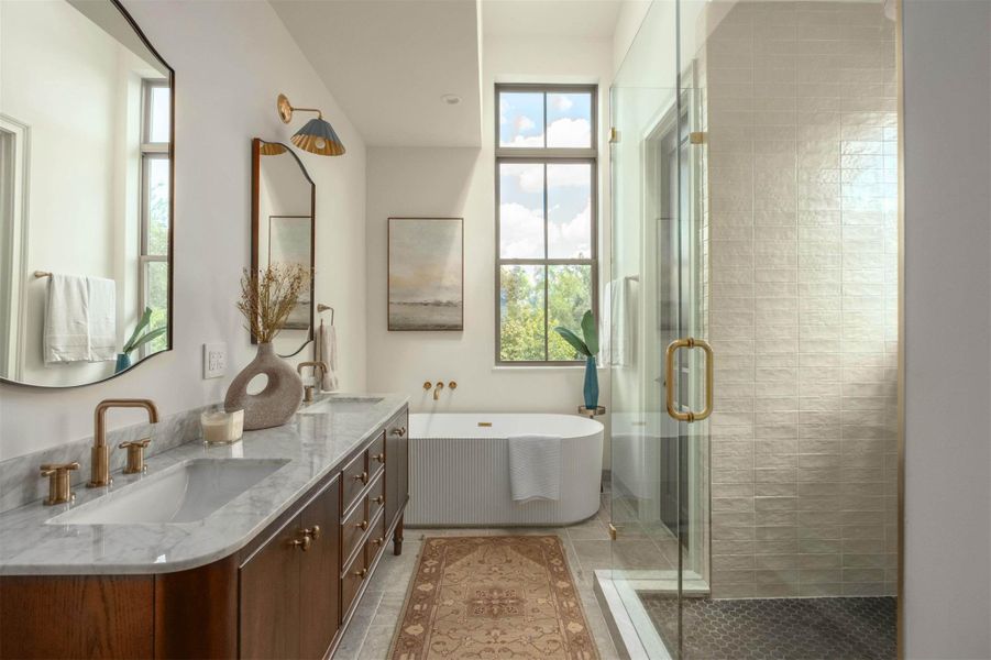 Soaring ceilings and a modern freestanding tub highlight this elegant primary bathroom. Soaring ceilings and a modern freestanding tub highlight this elegant primary bathroom.