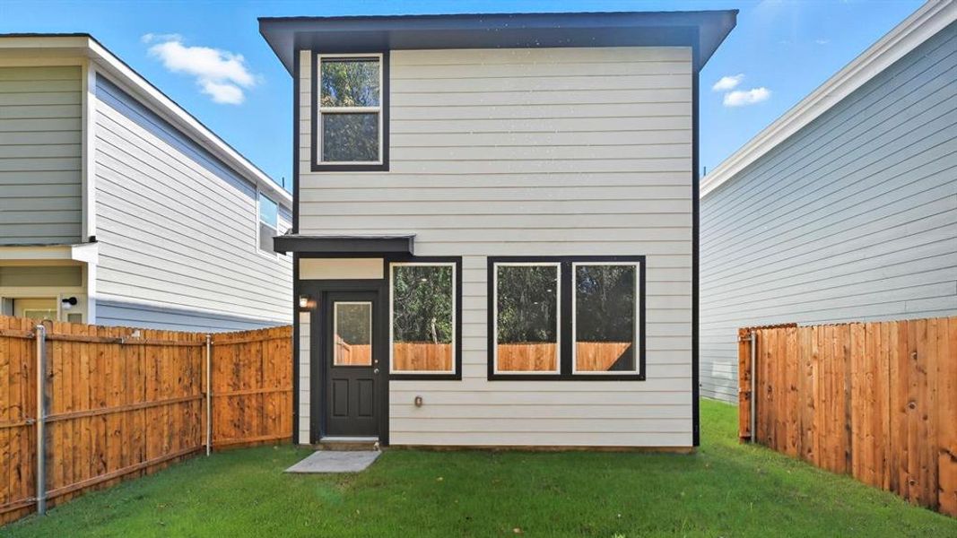 Back of house featuring a fenced backyard