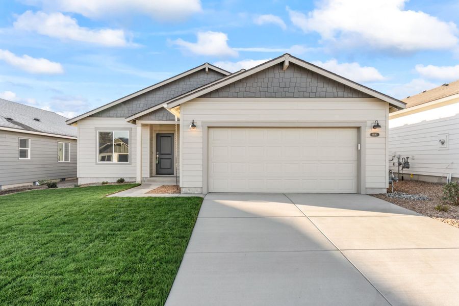 Front exterior of a new home in Feather Ridge, Redmond, OR, highlighting curb appeal (Image 1). Front exterior of a new home in Feather Ridge, Redmond, OR, highlighting curb appeal (Image 1).