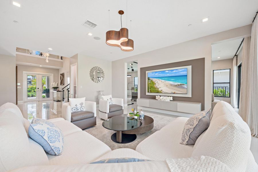 Decorative TV wall unit with built-in surround sound and ceiling-mounted speakers.