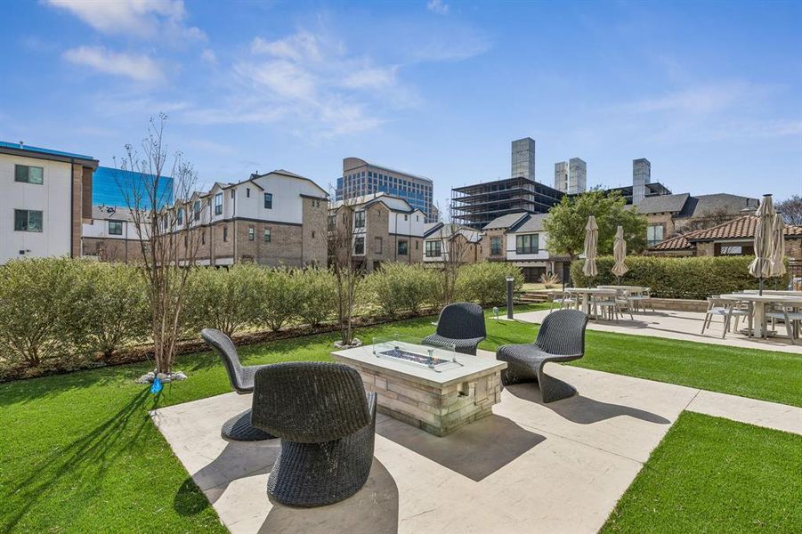 Outdoor area with gas firepit, outdoor kitchen and dining area