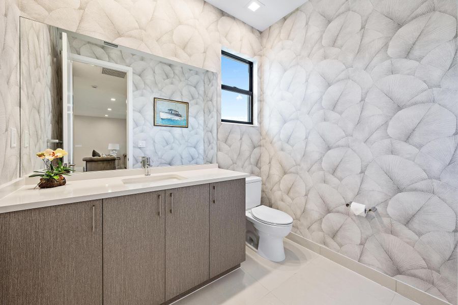 Designer-approved wallpaper and a large vanity.
