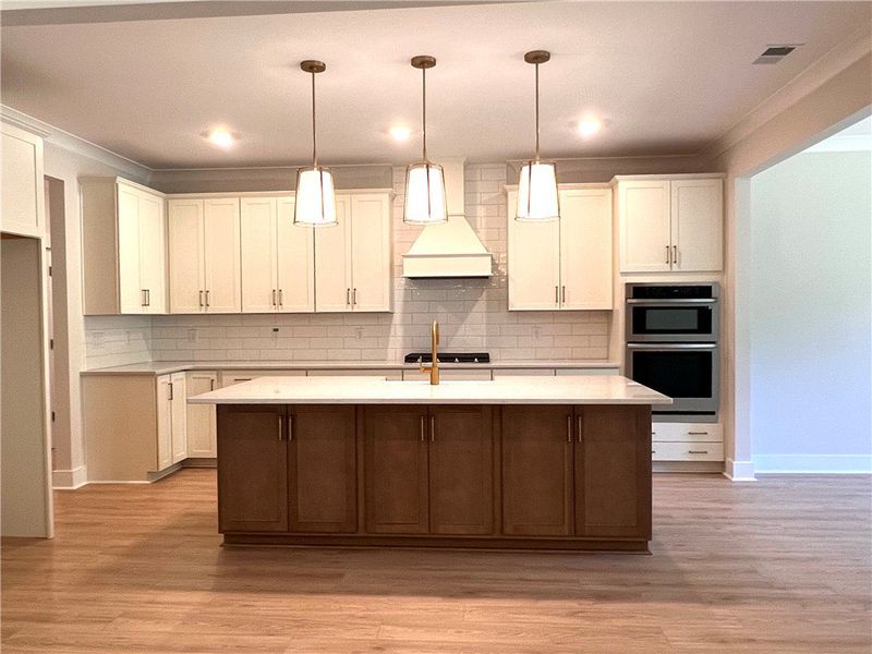 This expansive kitchen features a large island, pe