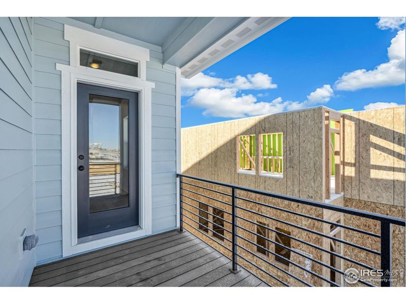Exterior details and patio area of a home in Kinston Mainstreet Townhomes, Loveland (Image 3).
