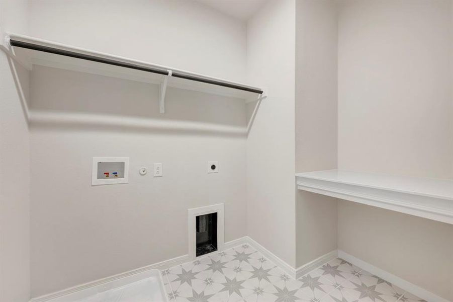 Laundry area featuring light floors, hookup for a gas dryer, washer hookup, and hookup for an electric dryer