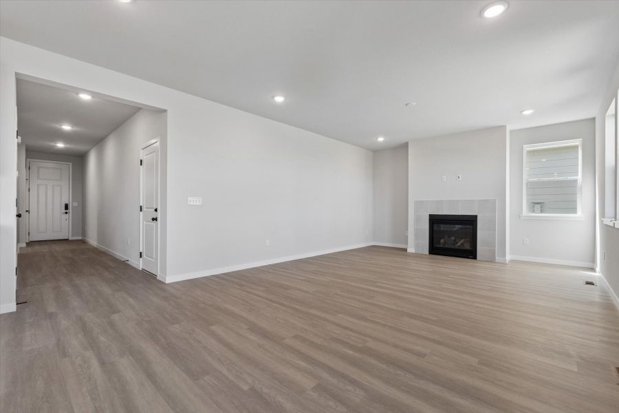 A large empty room with a fireplace.