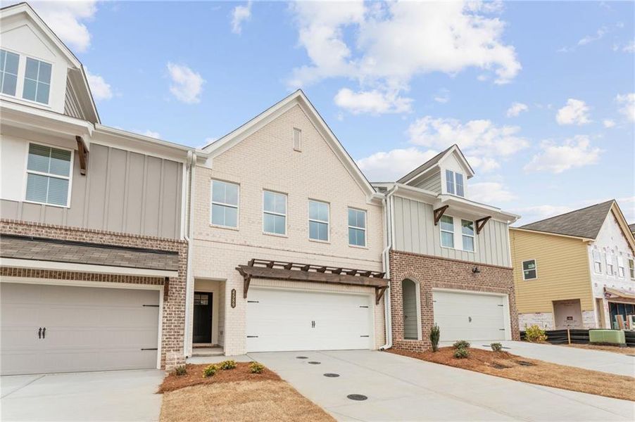 Front exterior of a new home in Bluffs at Bells Ferry, Marietta, GA, highlighting curb appeal (Image 1). Front exterior of a new home in Bluffs at Bells Ferry, Marietta, GA, highlighting curb appeal (Image 1).
