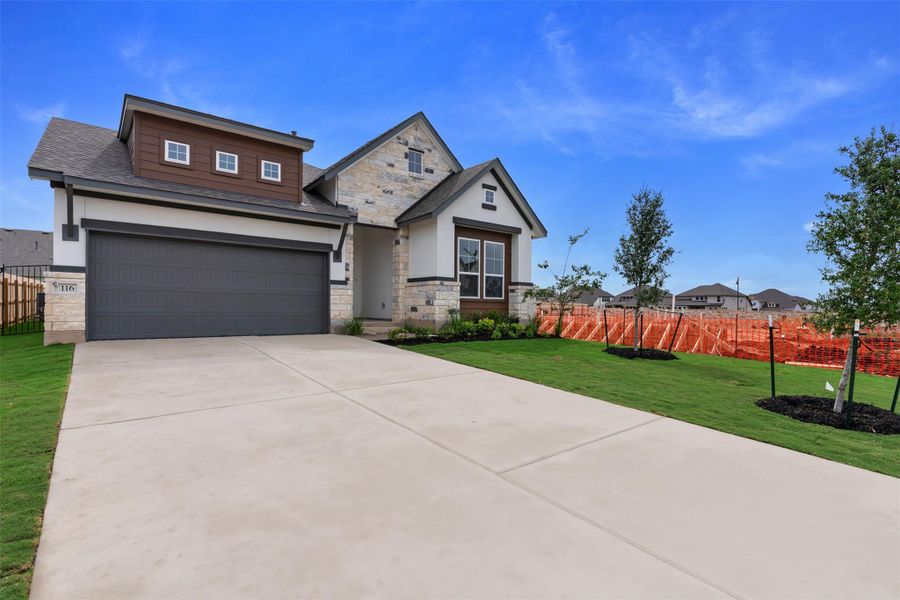 A contemporary facade showcases elegant stone and siding accents, complemented by a broad concrete driveway. A contemporary facade showcases elegant stone and siding accents, complemented by a broad concrete driveway.