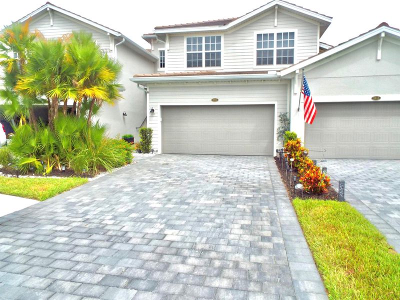 Front exterior of a new home in , Ave Maria, FL, highlighting curb appeal (Image 19).