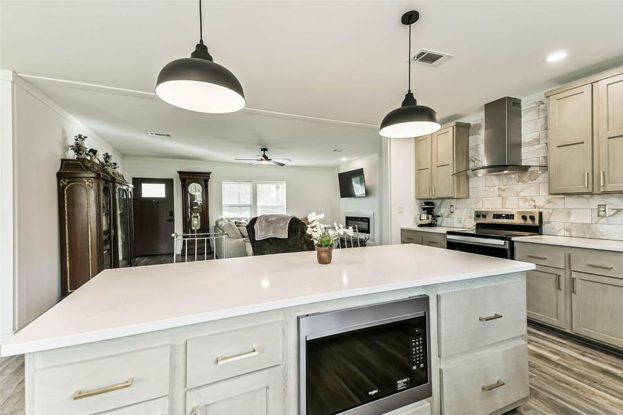 Island with pots & pans drawers, & pendant lighting