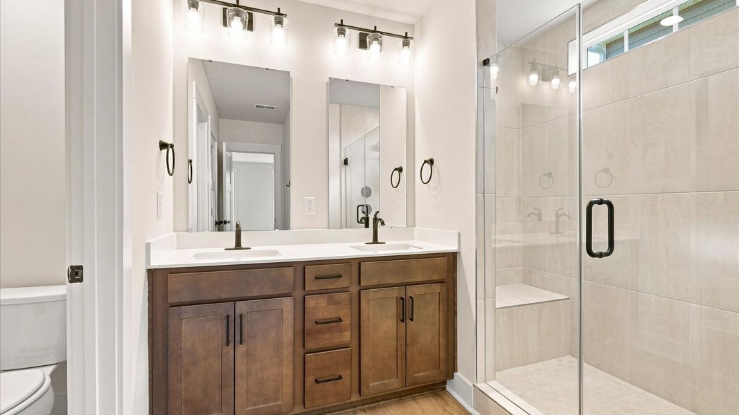 Memorable mornings begin in this elegant primary bathroom with walk-in shower and double vanity in Seneca, SC