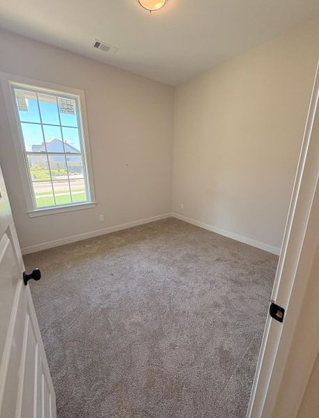 Neutral tone walls, white trim, and a window with grid detailing Neutral tone walls, white trim, and a window with grid detailing
