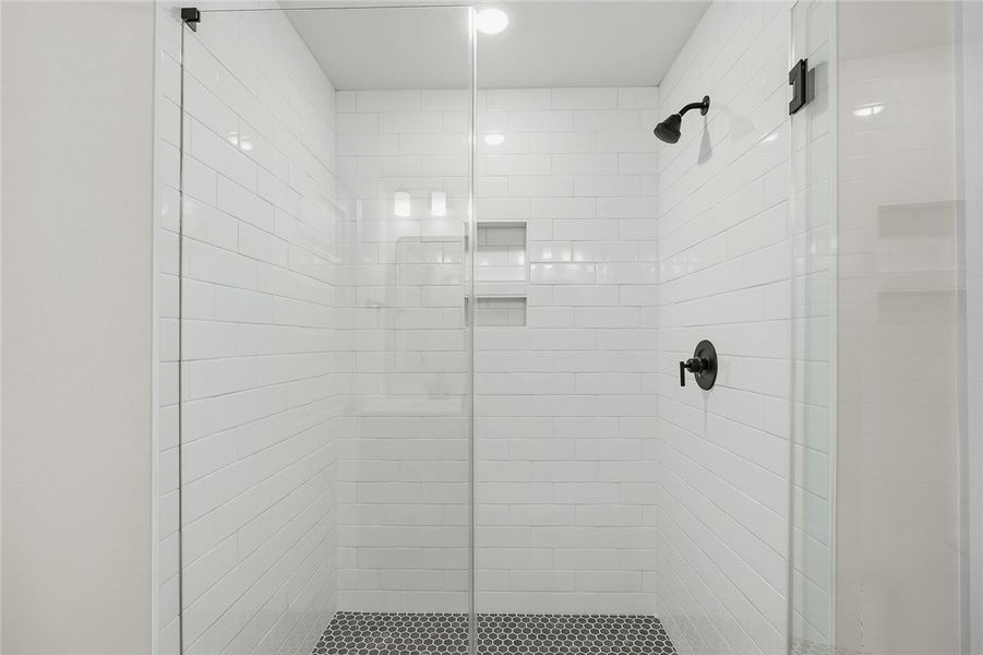 Modern tilework and sleek black fixtures highlight