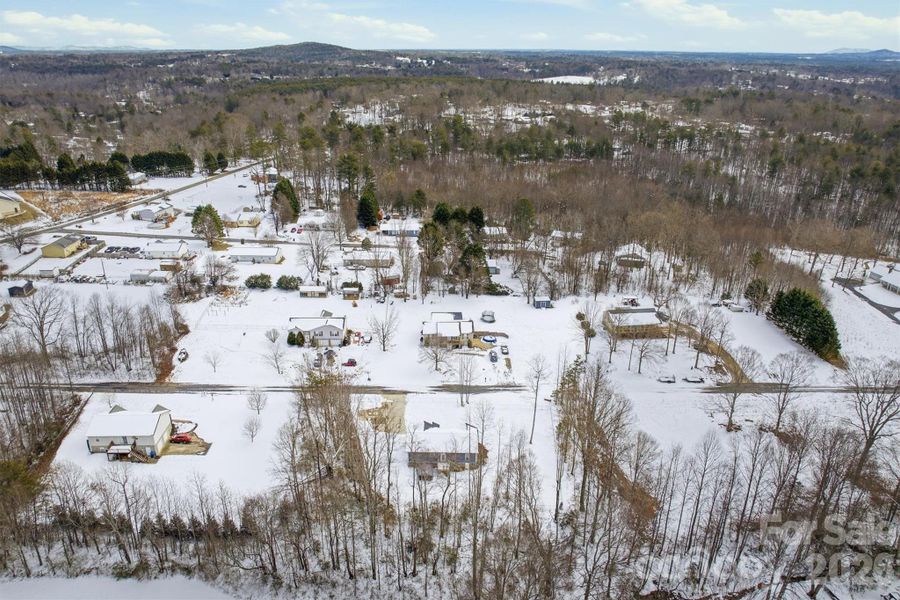 Aerial view of home in bottom center and neighborhood.