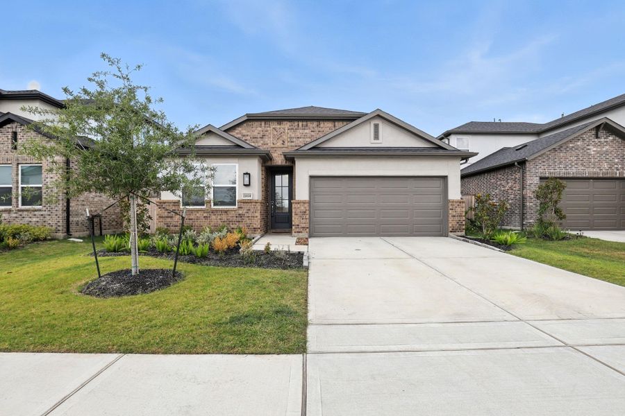 Front exterior of a new home in Bridge Creek 45s and 50s, Cypress, TX, highlighting curb appeal (Image 18). Front exterior of a new home in Bridge Creek 45s and 50s, Cypress, TX, highlighting curb appeal (Image 18).