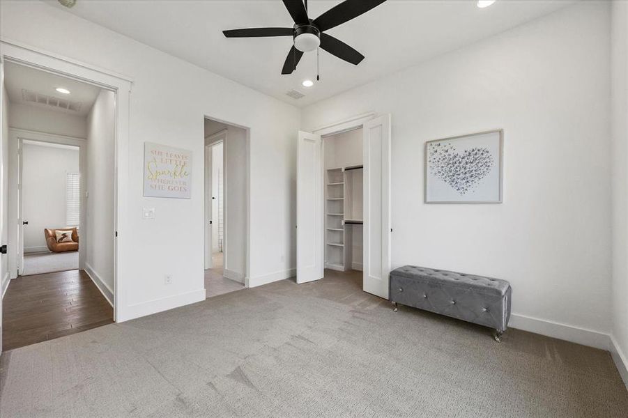 Unfurnished bedroom with ceiling fan, a closet, and carpet